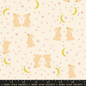 a pattern of pink and yellow rabbits and crescent moons against a starry night sky background.