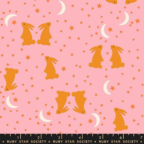 a pattern of rabbits and crescent moons against a pink background with stars.