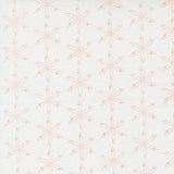 a repeating pattern of orange and white flowers or star-like shapes on a white background.