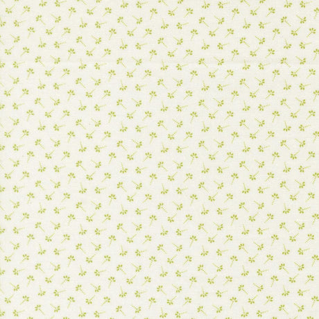 a repeating pattern of small green flowers or leaves on a light-colored background.