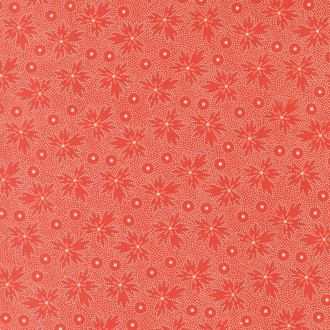 a repeating pattern of red flowers with white dots on a red background.