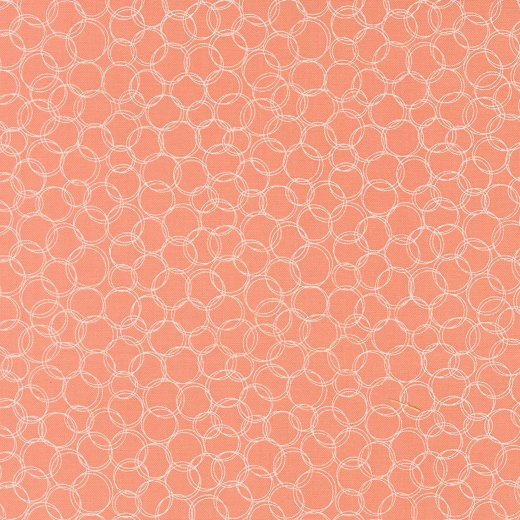 a repeating pattern of overlapping white circles on a peach-colored background.