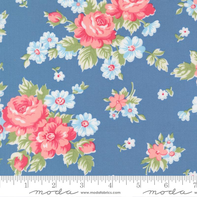 a blue fabric with a floral pattern of pink and white flowers.