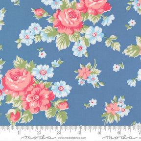 a blue fabric with a floral pattern of pink and white flowers.