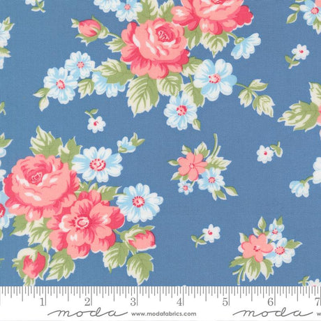 a blue fabric with a floral pattern of pink and white flowers.