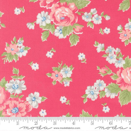 a vibrant pink fabric adorned with a floral pattern of white and pink flowers, along with green leaves. The fabric appears to be a part of a larger textile or garment, as indicated by the ruler for scale.