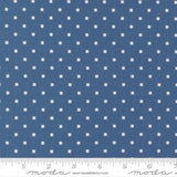 a close-up view of a fabric with a blue background and white polka dots. The fabric appears to be a type of material with a dotted pattern, possibly used for clothing or home decor.