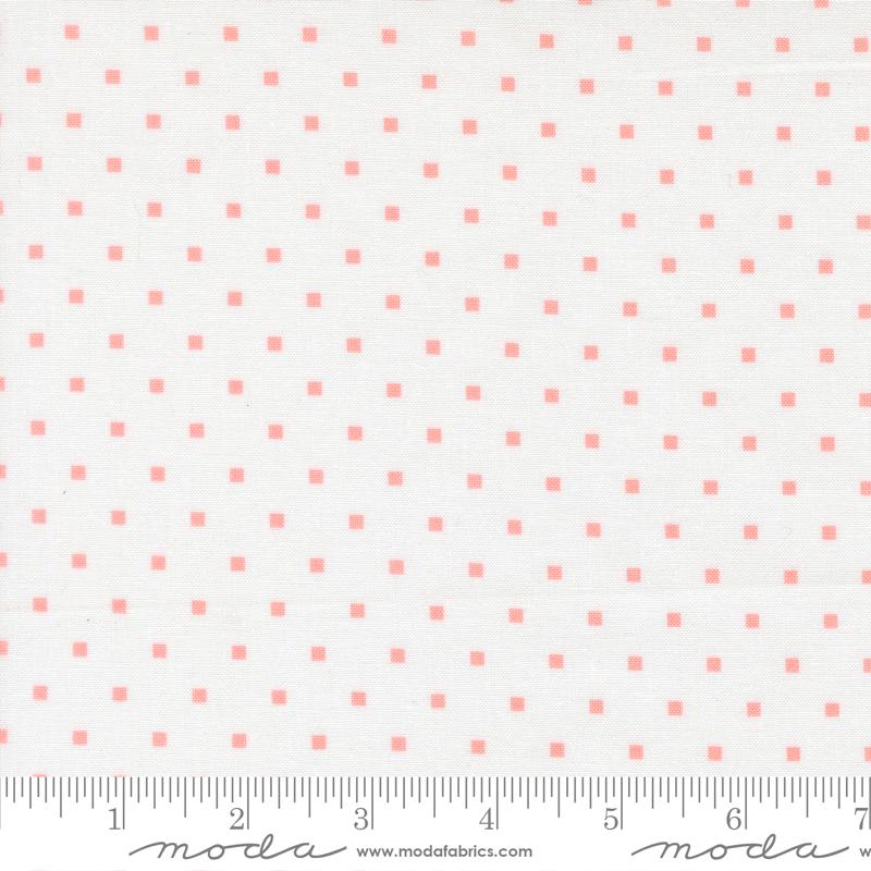 a fabric with a repeating pattern of small pink squares on a white background.