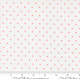 a fabric with a repeating pattern of small pink squares on a white background.