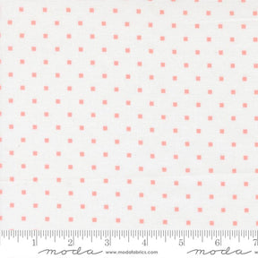 a fabric with a repeating pattern of small pink squares on a white background.
