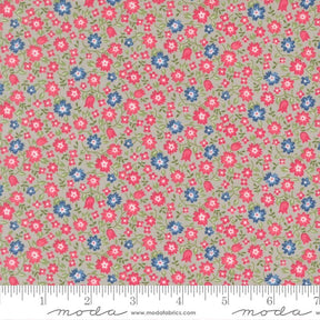 The image is a fabric with a floral pattern in shades of pink, blue, and green. The pattern consists of small flowers and leaves scattered across the fabric, creating a visually appealing and colorful design.