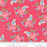 The image is a vibrant red fabric with a repeating paisley pattern of pink and blue flowers and leaves.