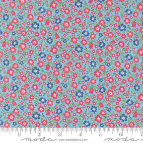 The image is a fabric with a floral pattern in shades of blue and red. The pattern consists of small flowers and leaves scattered across the fabric, creating a vibrant and colorful design.