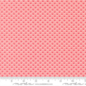 a repeating pattern of pink flowers on a fabric surface.