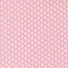 a repeating pattern of white flowers on a pink background.