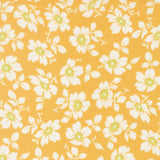 a repeating pattern of white flowers with green centers against a yellow background.