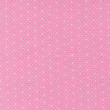 The image is a pink background with small white dots arranged in a pattern.