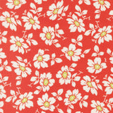 a repeating pattern of white flowers with green centers against a red background.