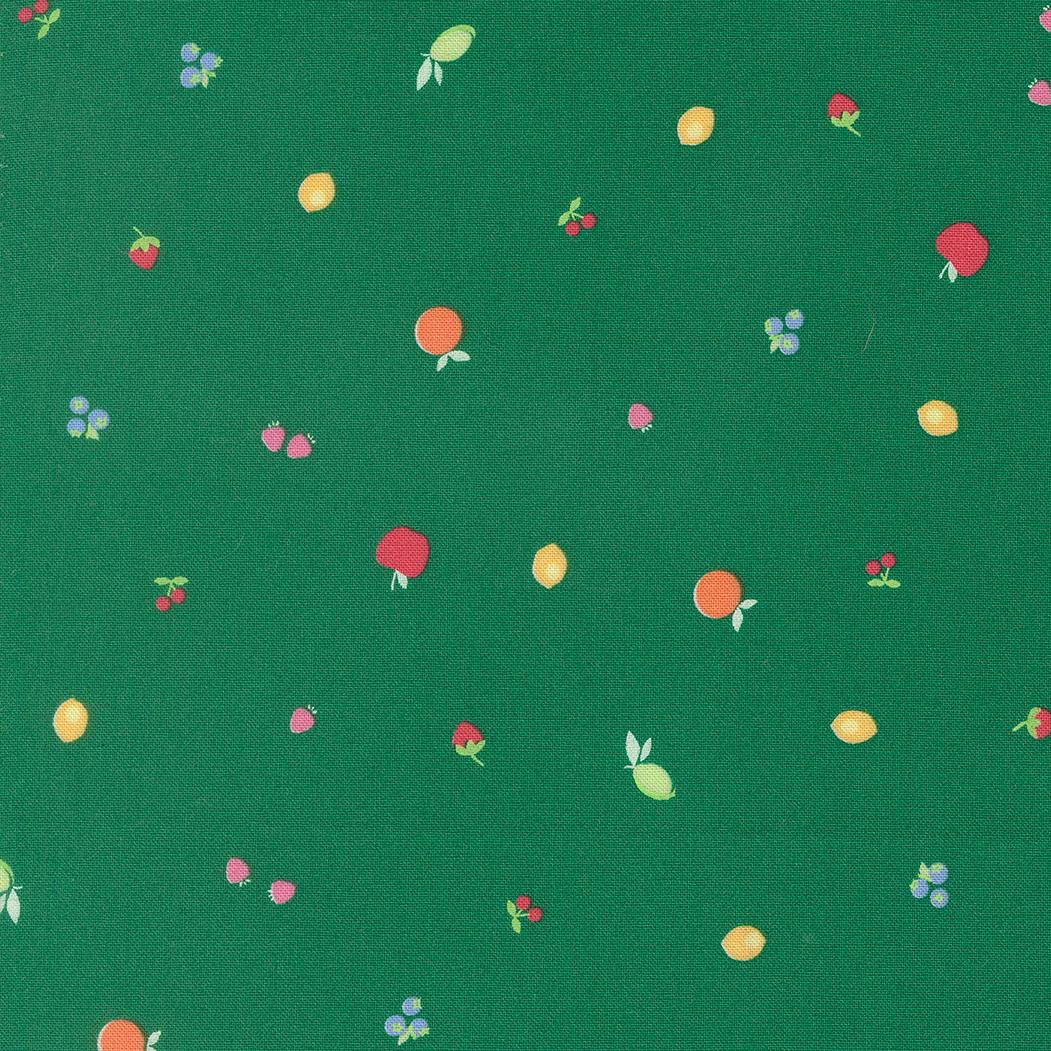 a variety of colorful fruits, including apples, oranges, and cherries, scattered across a green background.