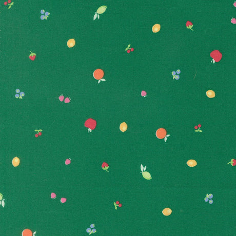 a variety of colorful fruits, including apples, oranges, and cherries, scattered across a green background.