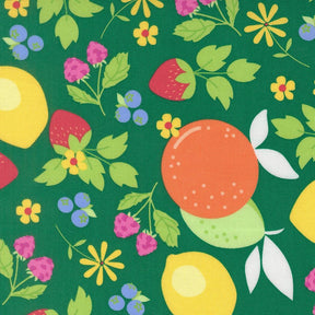 The image is a vibrant and colorful pattern featuring various fruits and flowers on a green background.