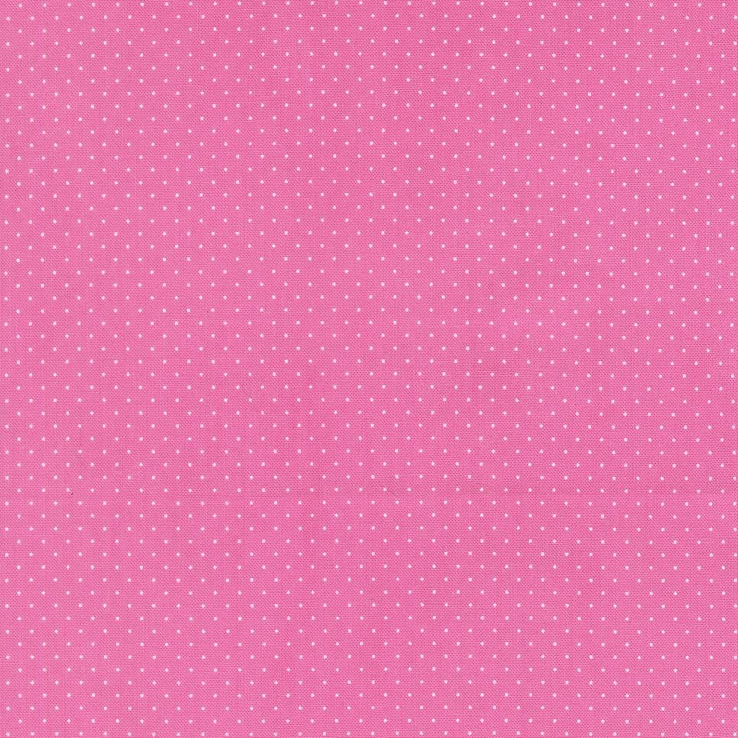 The image is a pink background with small white dots or stars scattered across it.