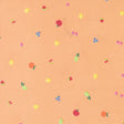 a pattern of various fruits, including apples, oranges, and cherries, scattered across a peach-colored background.