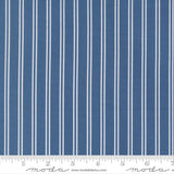 a close-up view of a fabric with vertical white stripes. The fabric appears to be a solid blue color, with the white stripes contrasting against the blue background. The image does not contain any text or additional objects, and the focus is solely on the fabric and its striped pattern.