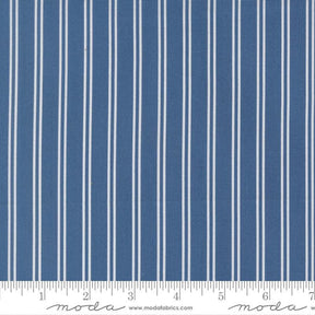a close-up view of a fabric with vertical white stripes. The fabric appears to be a solid blue color, with the white stripes contrasting against the blue background. The image does not contain any text or additional objects, and the focus is solely on the fabric and its striped pattern.