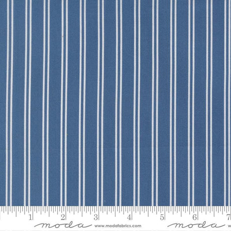 a close-up view of a fabric with vertical white stripes. The fabric appears to be a solid blue color, with the white stripes contrasting against the blue background. The image does not contain any text or additional objects, and the focus is solely on the fabric and its striped pattern.
