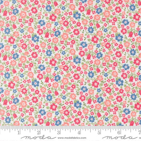 a fabric with a floral pattern in shades of pink, blue, and green. The fabric appears to be a light-colored material, possibly cotton or linen, with a repeating pattern of small flowers and leaves. The image does not contain any text or additional objects, and the focus is on the floral pattern.