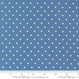 a close-up view of a fabric with a blue background and white polka dots. The fabric appears to be a type of textile, possibly used for clothing or home decor.