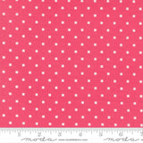 a close-up view of a fabric with a repeating pattern of small white squares against a bright pink background.