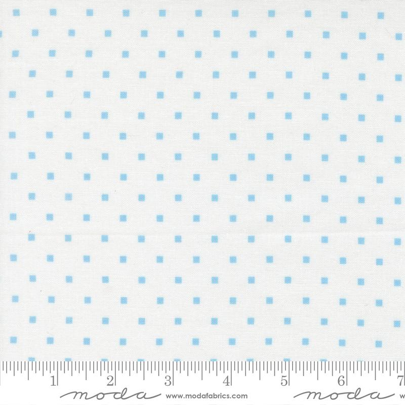 a fabric with a blue dot pattern, and it is being measured for size.