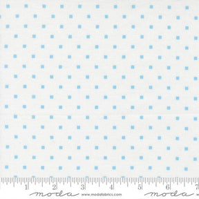 a fabric with a blue dot pattern, and it is being measured for size.