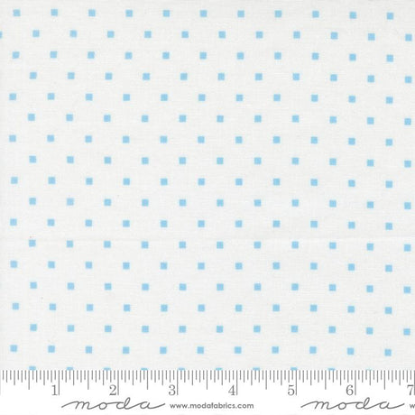 a fabric with a blue dot pattern, and it is being measured for size.