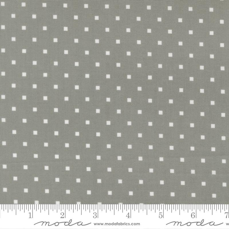 a grey fabric with white polka dots, and there is a ruler at the bottom of the image indicating the fabric's size.