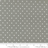 a grey fabric with white polka dots, and there is a ruler at the bottom of the image indicating the fabric's size.