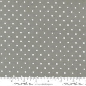 a grey fabric with white polka dots, and there is a ruler at the bottom of the image indicating the fabric's size.