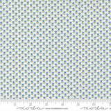 a fabric with a repeating pattern of blue flowers on a white background. The pattern is arranged in a grid-like fashion, creating a visually appealing and intricate design.