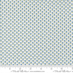a fabric with a repeating pattern of blue flowers on a white background. The pattern is arranged in a grid-like fashion, creating a visually appealing and intricate design.