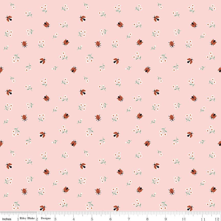a repeating pattern of small ladybugs and flowers on a light pink background.