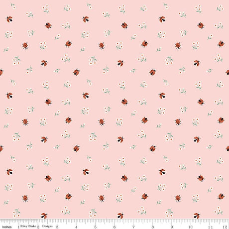 a repeating pattern of small ladybugs and flowers on a light pink background.