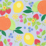 The image is a vibrant and colorful pattern featuring various fruits and flowers, including oranges, lemons, strawberries, blueberries, and daisies, all set against a light blue background.
