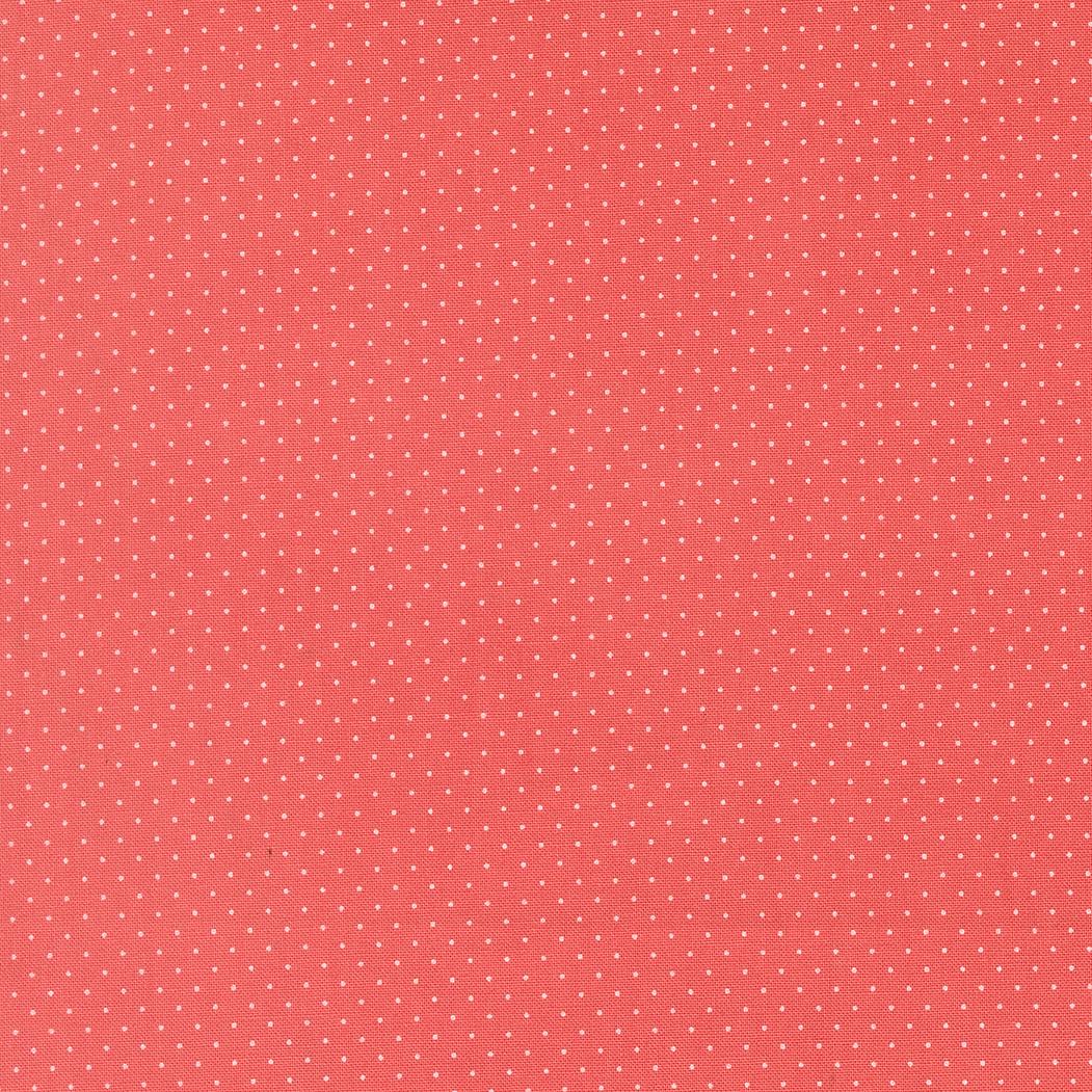 The image is a red background with small white dots, creating a polka dot pattern.