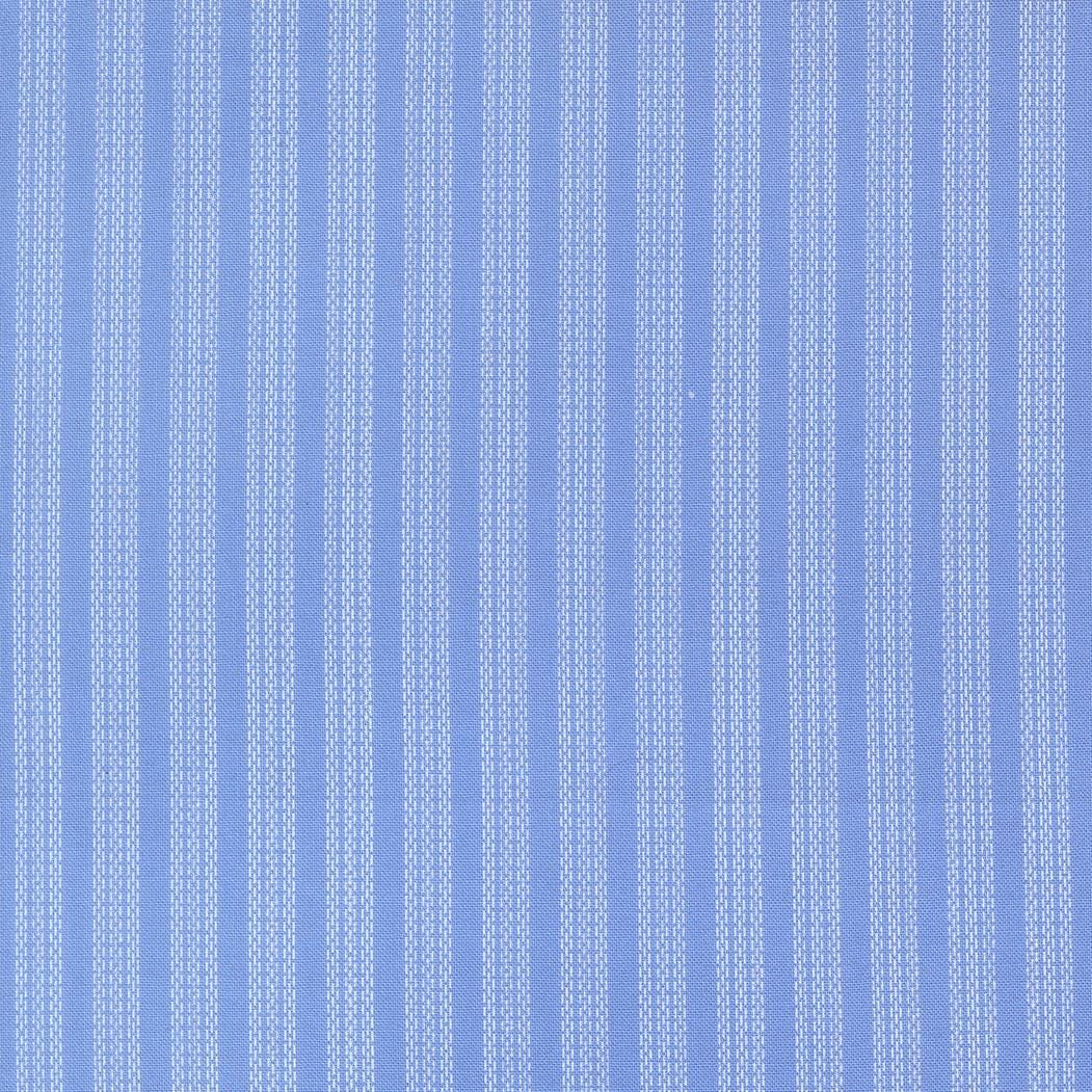 The image is a close-up of a fabric with vertical stripes in a light blue color. The fabric appears to be made of a material with a striped pattern, which is commonly used for clothing items such as shirts or dresses.