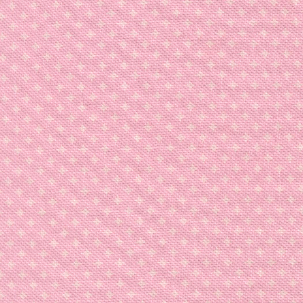 The image is a pink fabric with white polka dots, creating a playful and cheerful pattern.