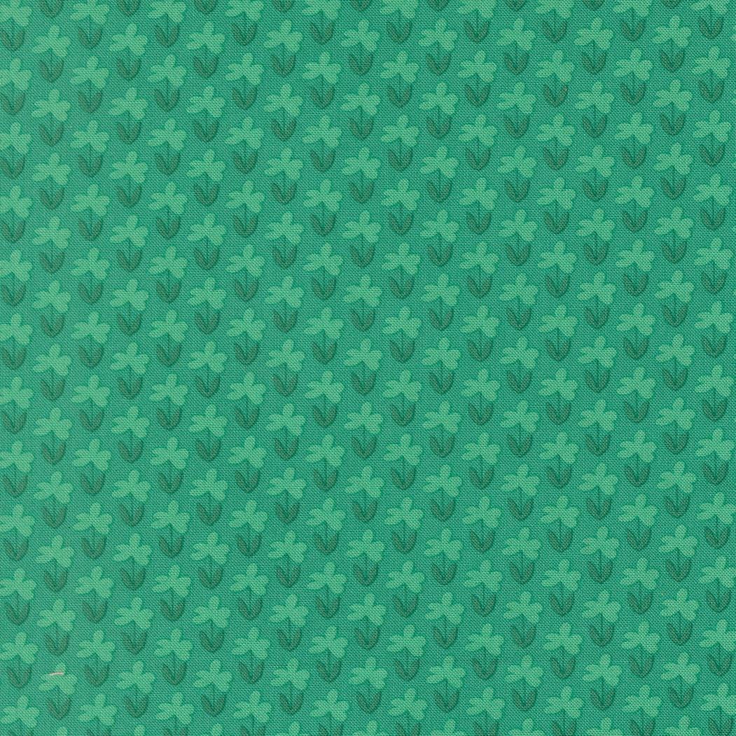 a repeating pattern of green flowers on a green background.