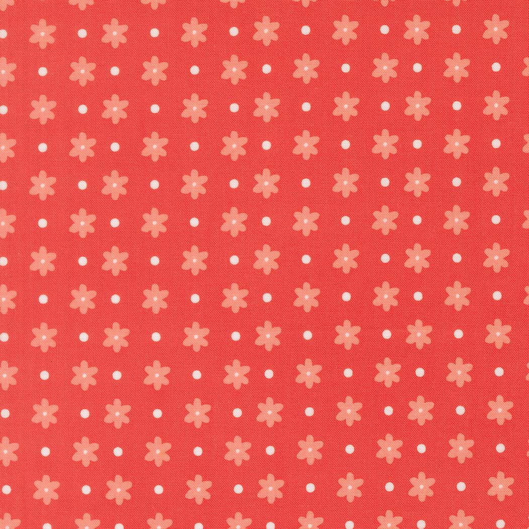 a repeating pattern of red flowers with white polka dots on a red background.