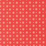 a repeating pattern of red flowers with white polka dots on a red background.